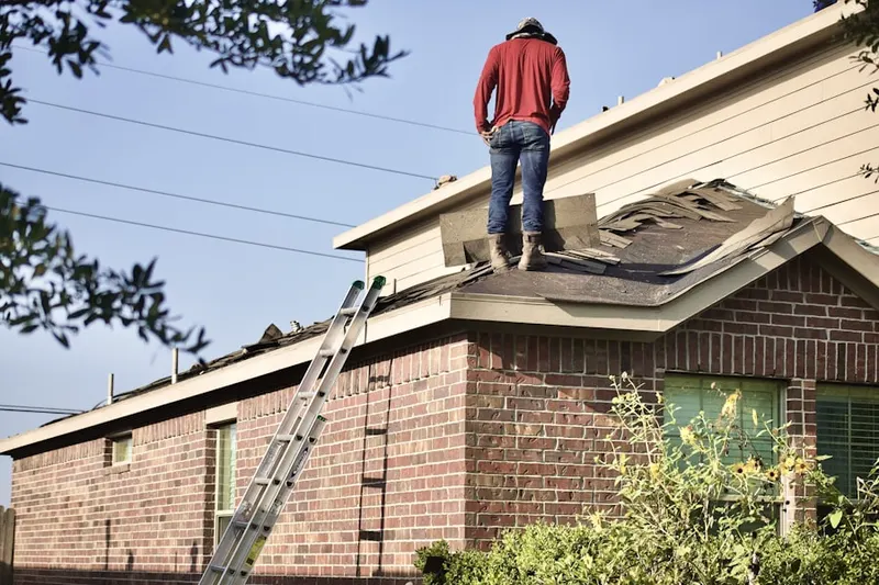 Professional roofer working on a residential roof in Clicquot